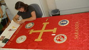 Skilled embroideress working on clerical banner